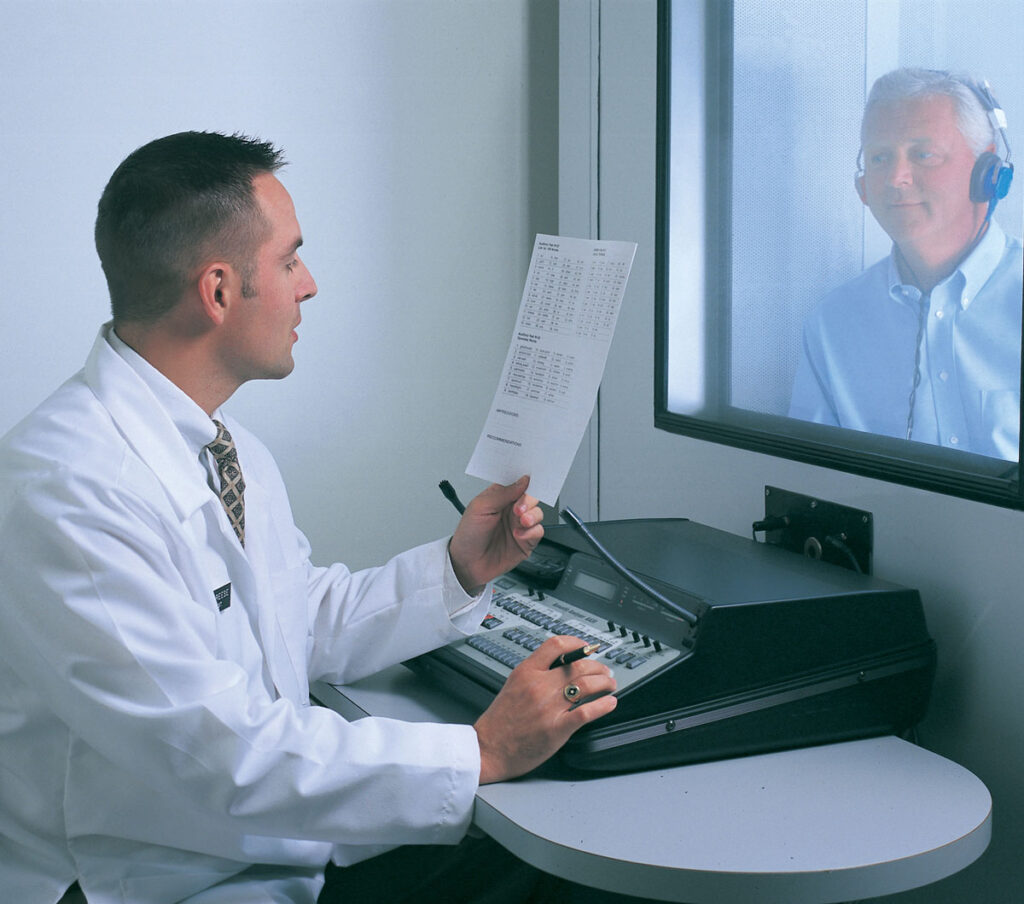 image of a hearing aid specialist giving a free hearing test to a new patient.