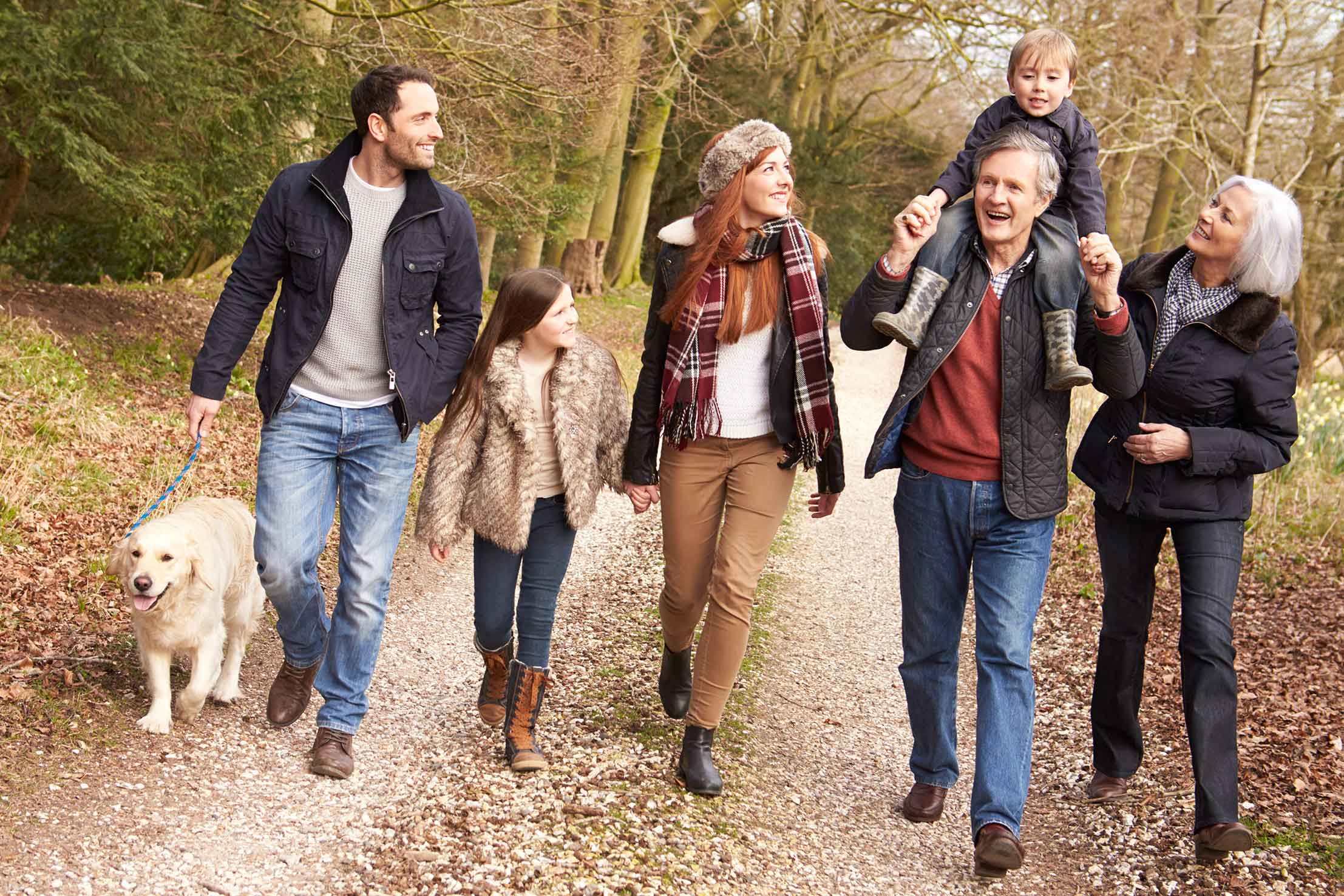 a large family on a fall hike talking and laughing showing you can still enjoy a good quality of life with hearing loss.