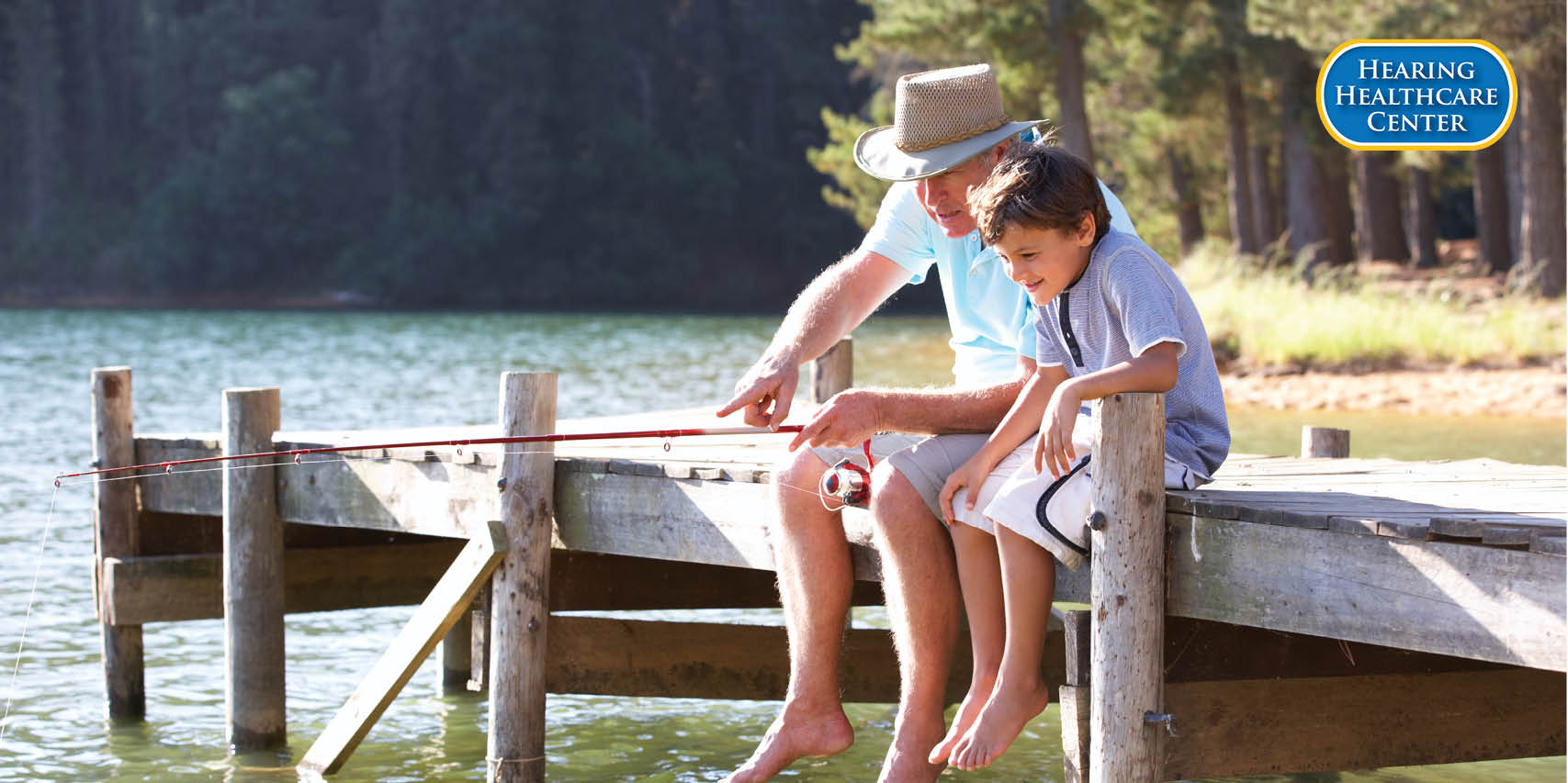 A grand father and boy fishing showing spring is here and its time to get your hearing checked.
